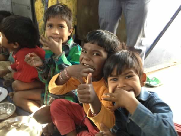 India_122512_Jeb_Butler_three_local_children_eating_good_photo