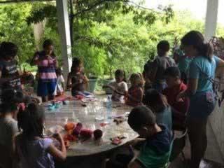 My daughter doing crafting with the children  (She is the one with the blue t-shirt with her back to us)